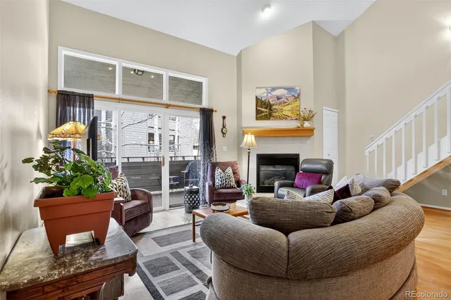 a living room with furniture a fireplace and a potted plant
