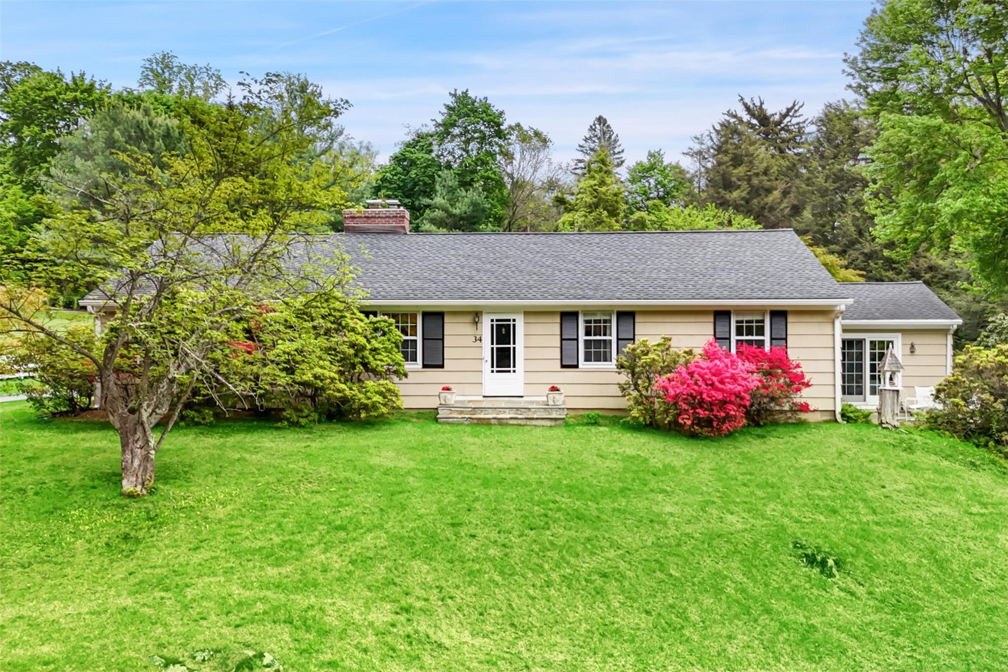 a front view of a house with garden