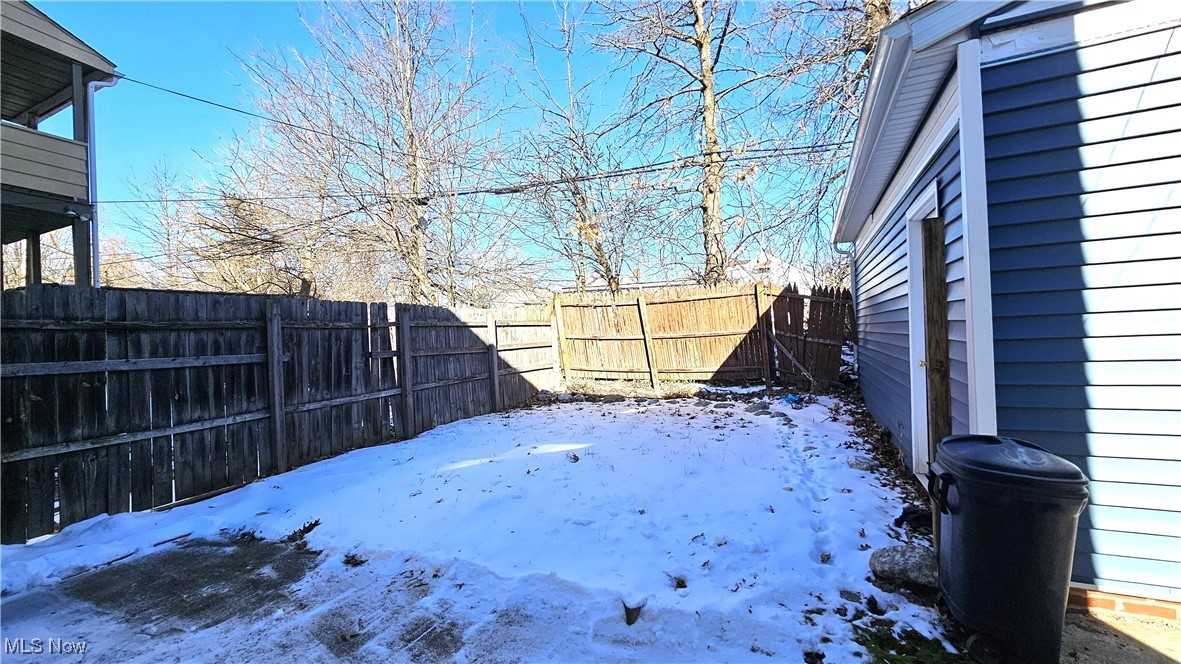 887 Rondel Road Cleveland, OH 44110 - Photo 7 of 34 View of rear yard covered in snow