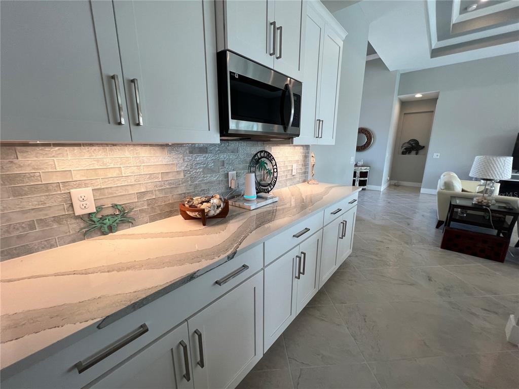15419 Appleton Boulevard Port Charlotte, FL 33981 - Photo 11 of 43 a large kitchen with cabinets