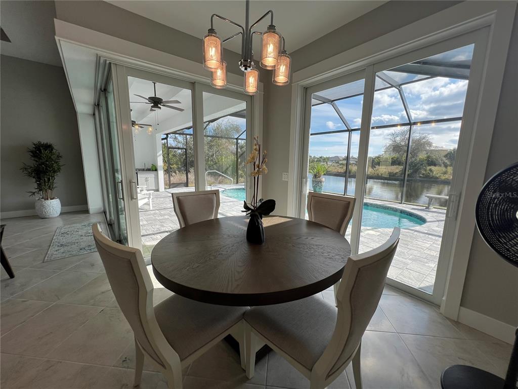 15419 Appleton Boulevard Port Charlotte, FL 33981 - Photo 12 of 43 a dining room with furniture wooden floor and a chandelier