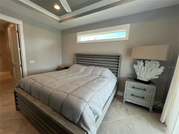 a bedroom with a bed a dresser and a mirror