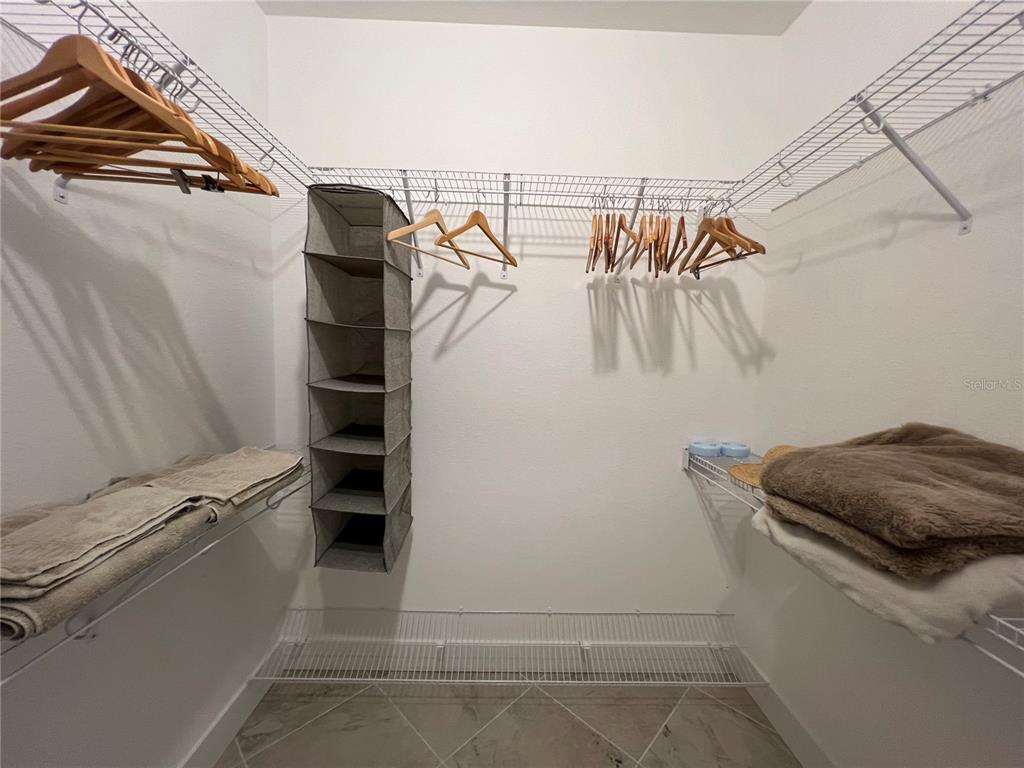 15419 Appleton Boulevard Port Charlotte, FL 33981 - Photo 18 of 43 a view of walk in closet with clothes and shoes