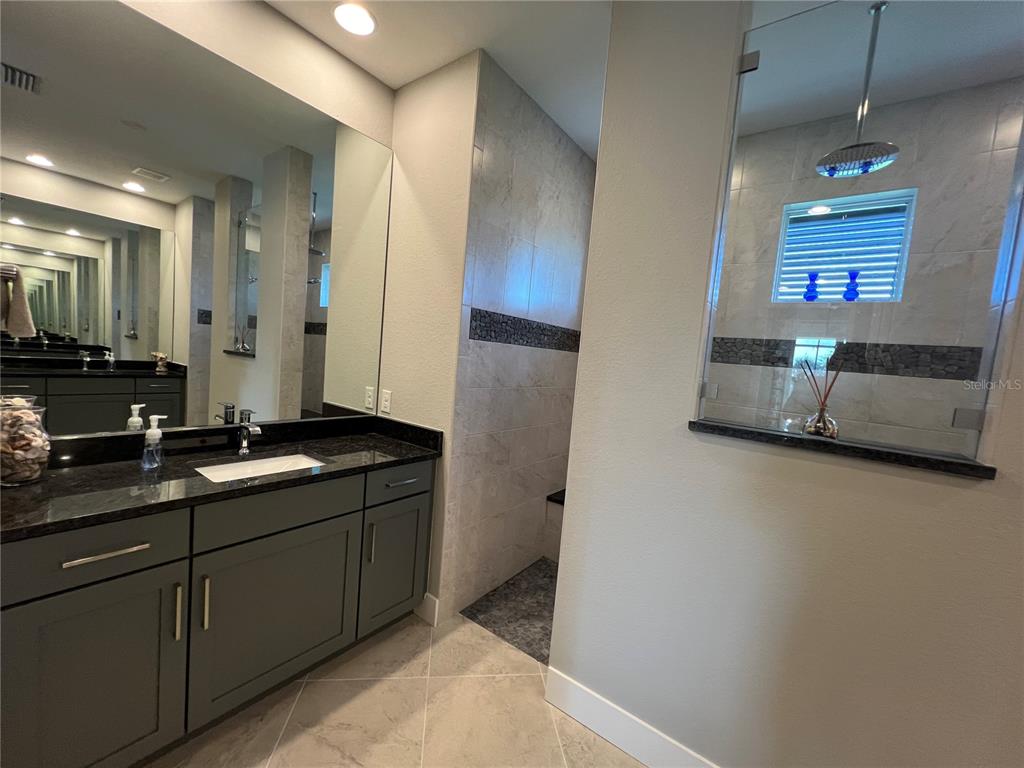 15419 Appleton Boulevard Port Charlotte, FL 33981 - Photo 19 of 43 a bathroom with double vanity and a mirror