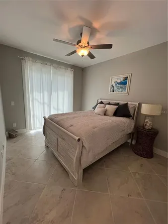 a bedroom with a bed and a chandelier