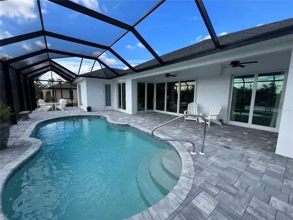 a house with swimming pool in front of it