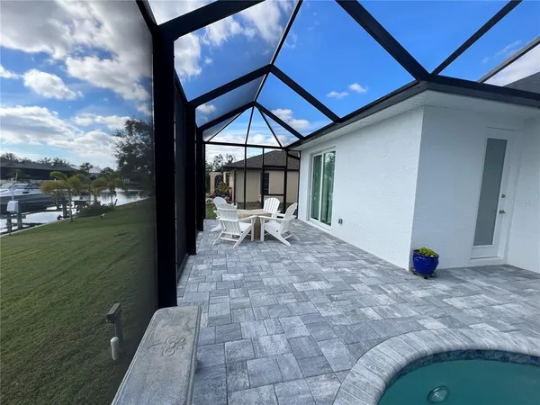 a view of patio with table and chairs under an umbrella