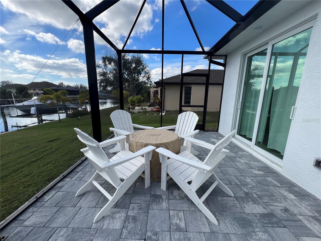 15419 Appleton Boulevard Port Charlotte, FL 33981 - Photo 36 of 43 a view of patio with table and chairs under an umbrella