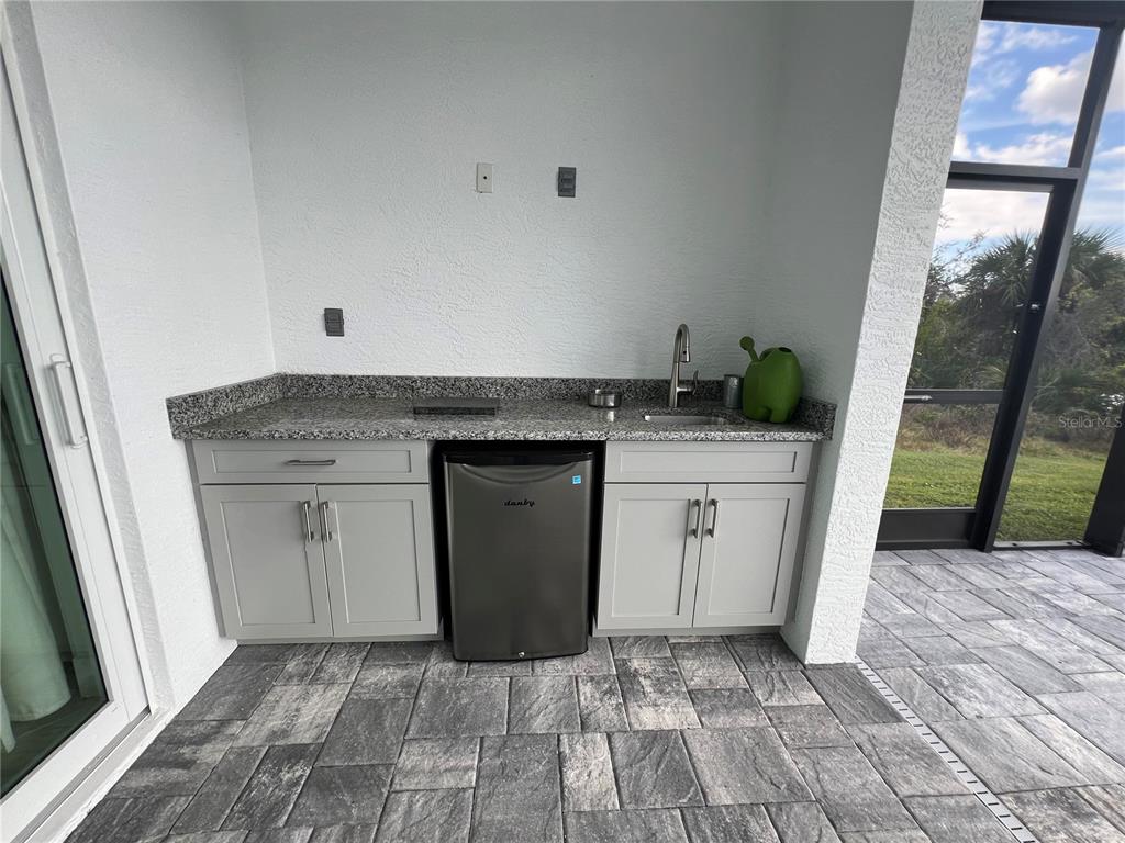 15419 Appleton Boulevard Port Charlotte, FL 33981 - Photo 39 of 43 a kitchen with a sink and cabinets