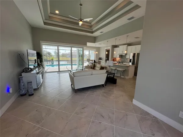 a living room with furniture and a chandelier