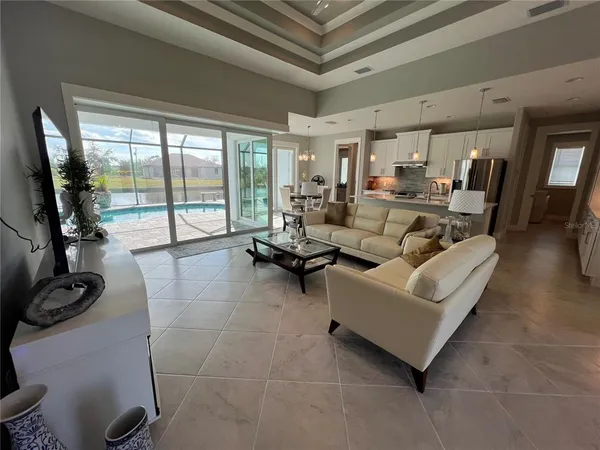 a living room with furniture and a floor to ceiling window