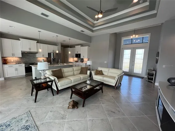 a living room with furniture and a chandelier