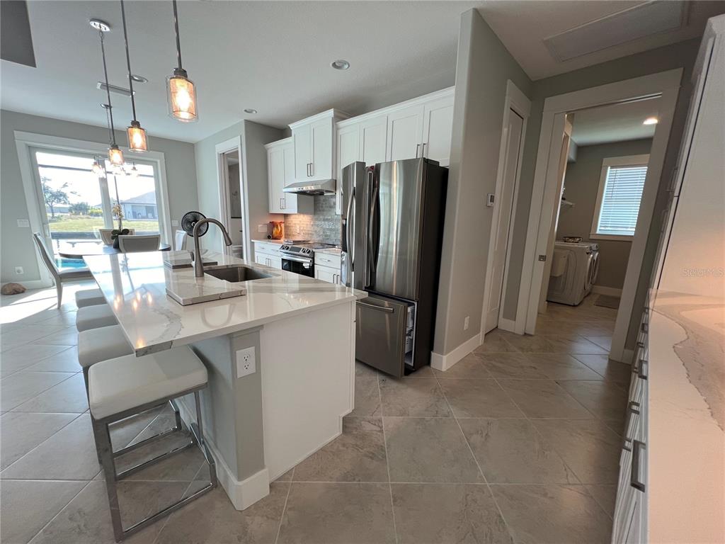 15419 Appleton Boulevard Port Charlotte, FL 33981 - Photo 9 of 43 a kitchen with refrigerator and window