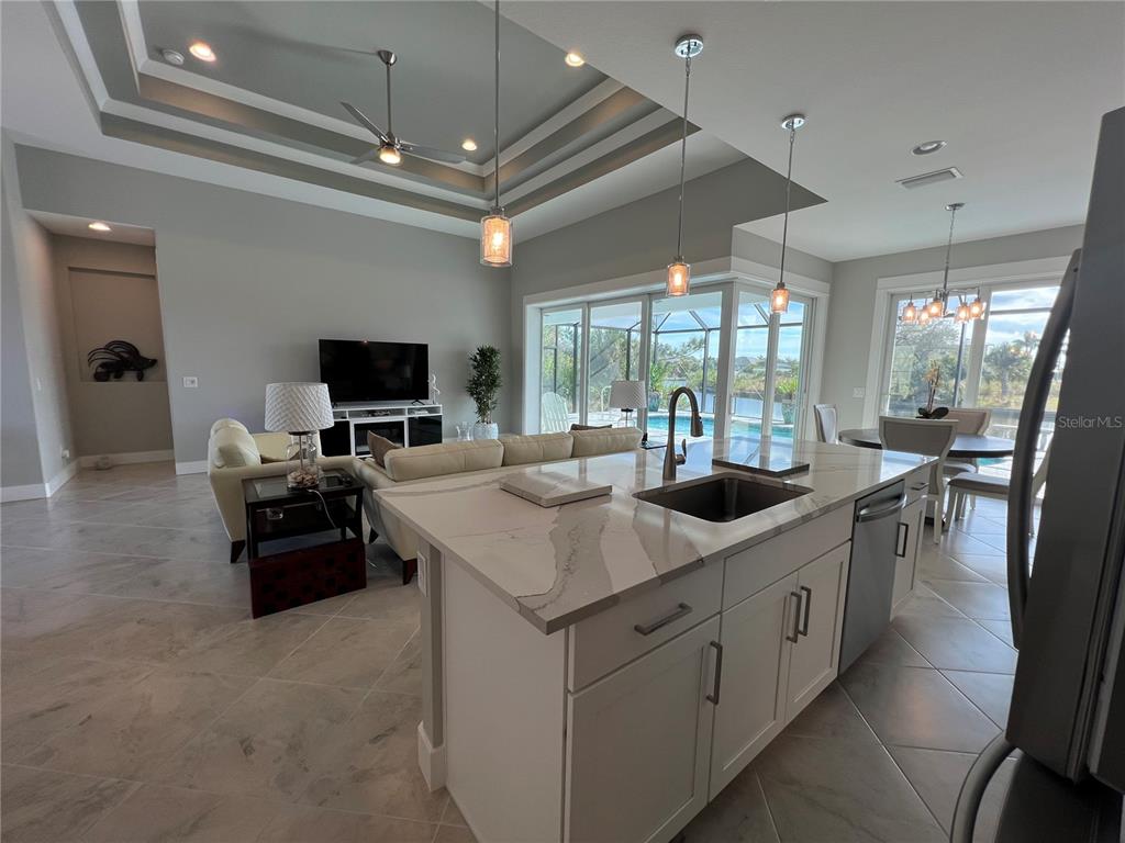 15419 Appleton Boulevard Port Charlotte, FL 33981 - Photo 10 of 43 a kitchen with kitchen island granite countertop a sink appliances and cabinets