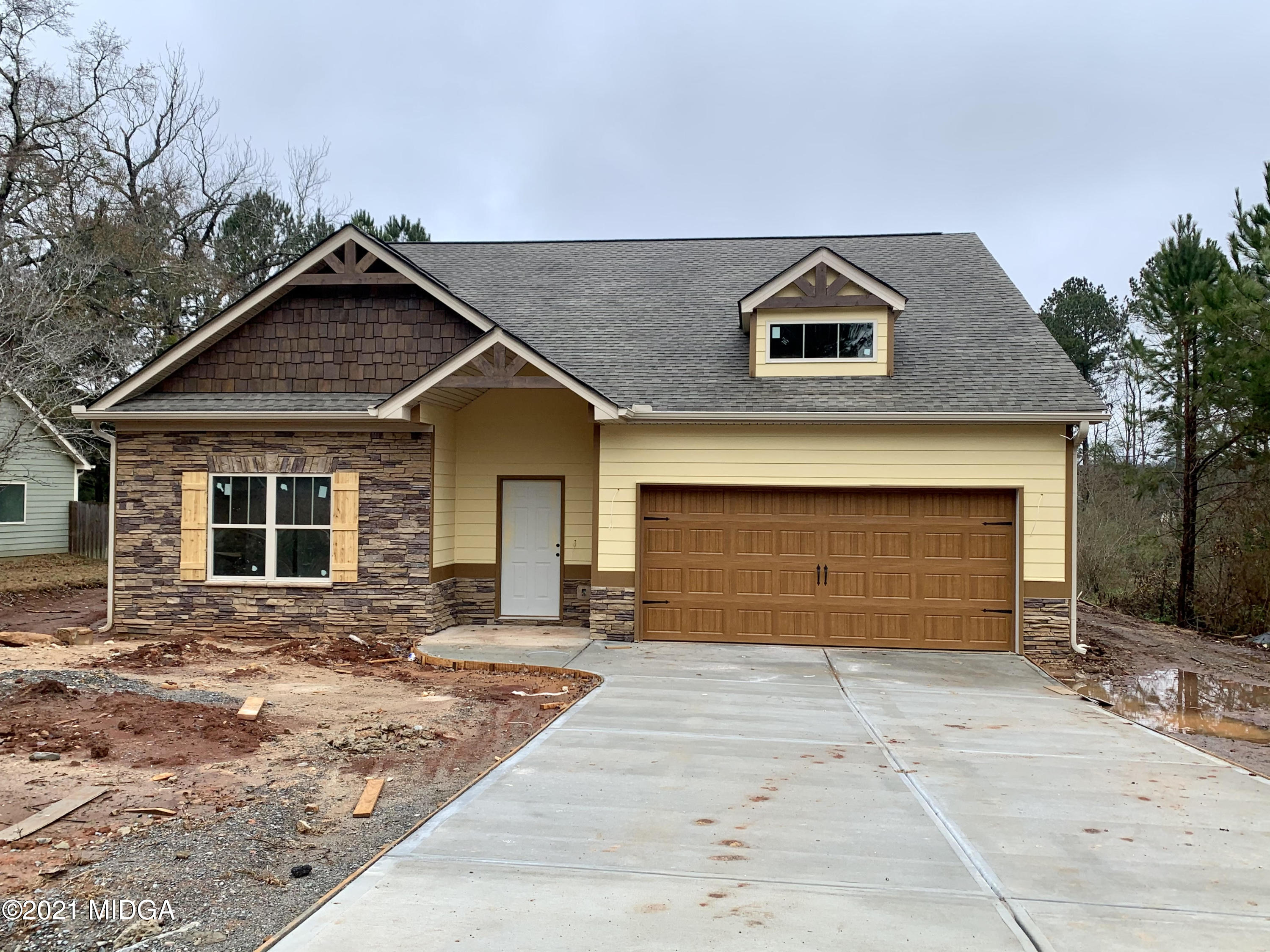 349 Walnut Grove Road Gray, GA 31032 - Photo 1 of 1 a front view of a house with a yard and garage