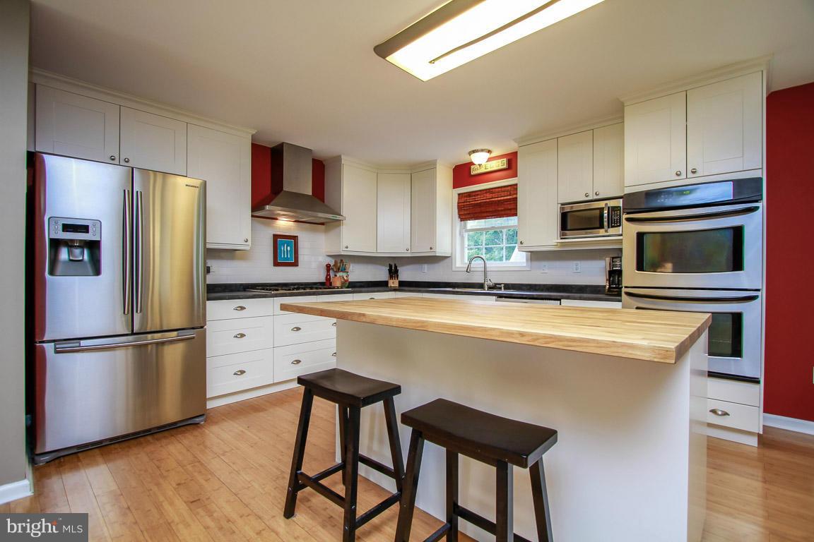 3237 Lineboro Road Manchester, MD 21102 - Photo 12 of 26 a kitchen with stainless steel appliances a refrigerator stove microwave and cabinets