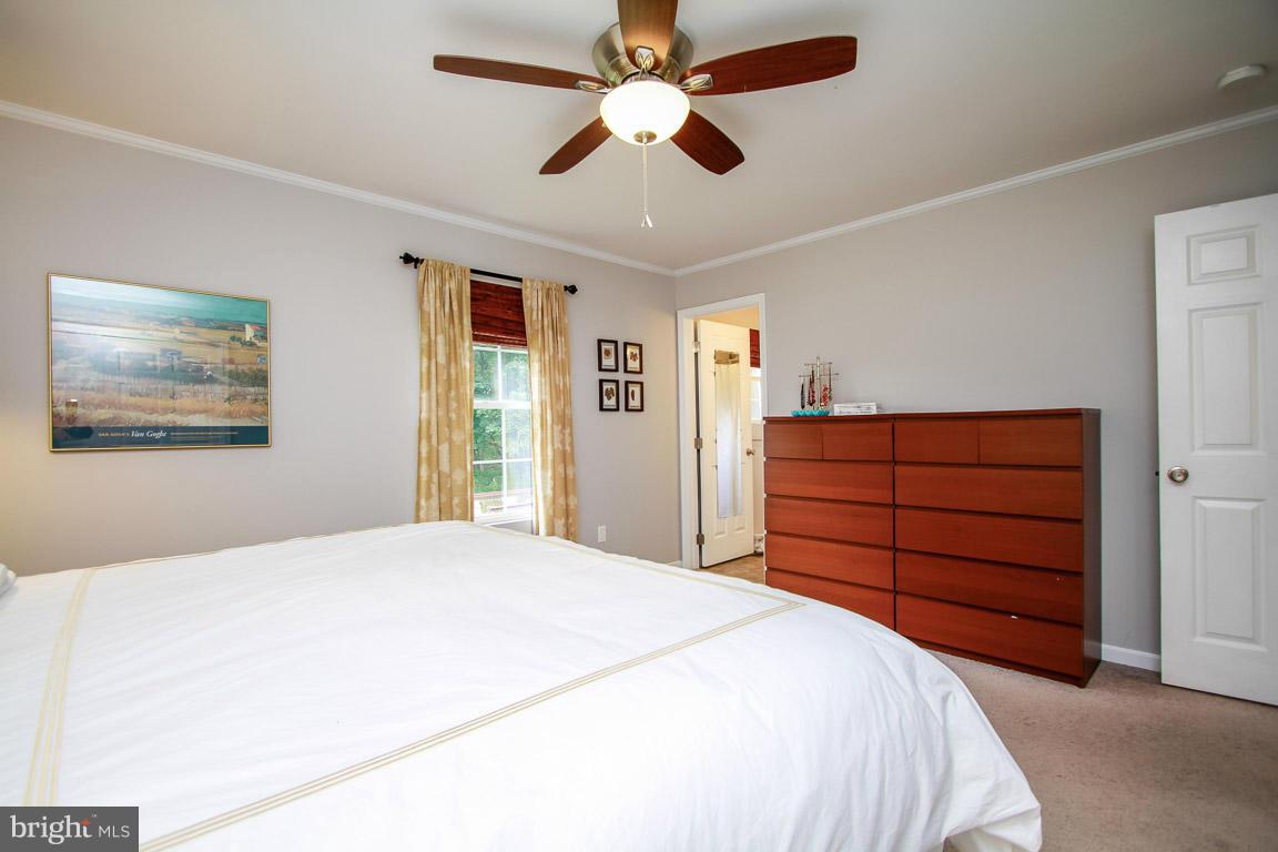 3237 Lineboro Road Manchester, MD 21102 - Photo 16 of 26 a bedroom with a bed and a chandelier