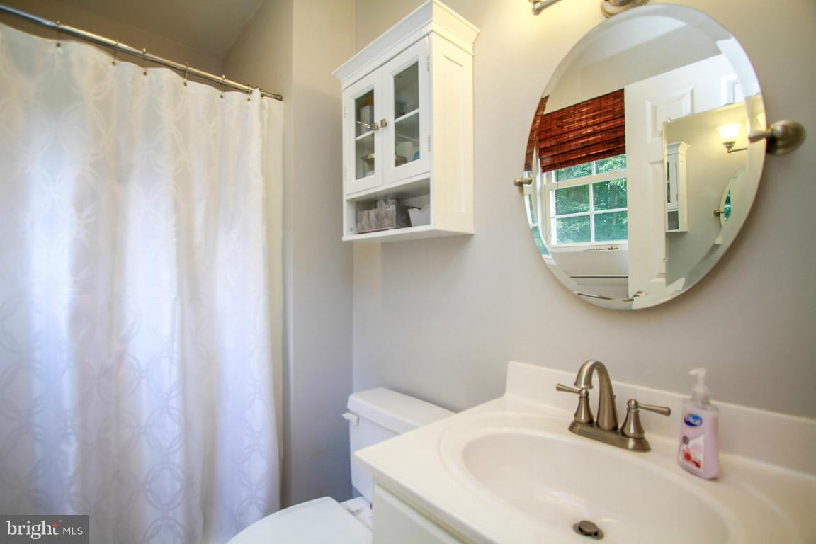 3237 Lineboro Road Manchester, MD 21102 - Photo 17 of 26 a bathroom with a sink a mirror and a toilet