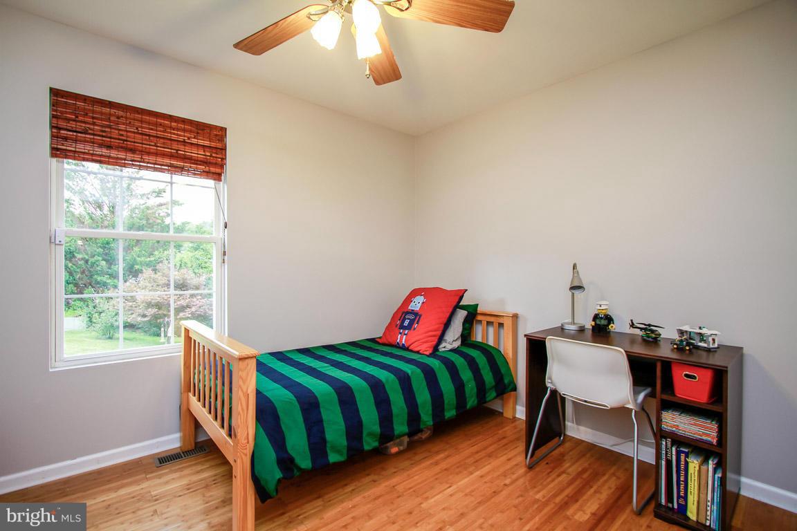 3237 Lineboro Road Manchester, MD 21102 - Photo 20 of 26 a bedroom with a bed and wooden floor