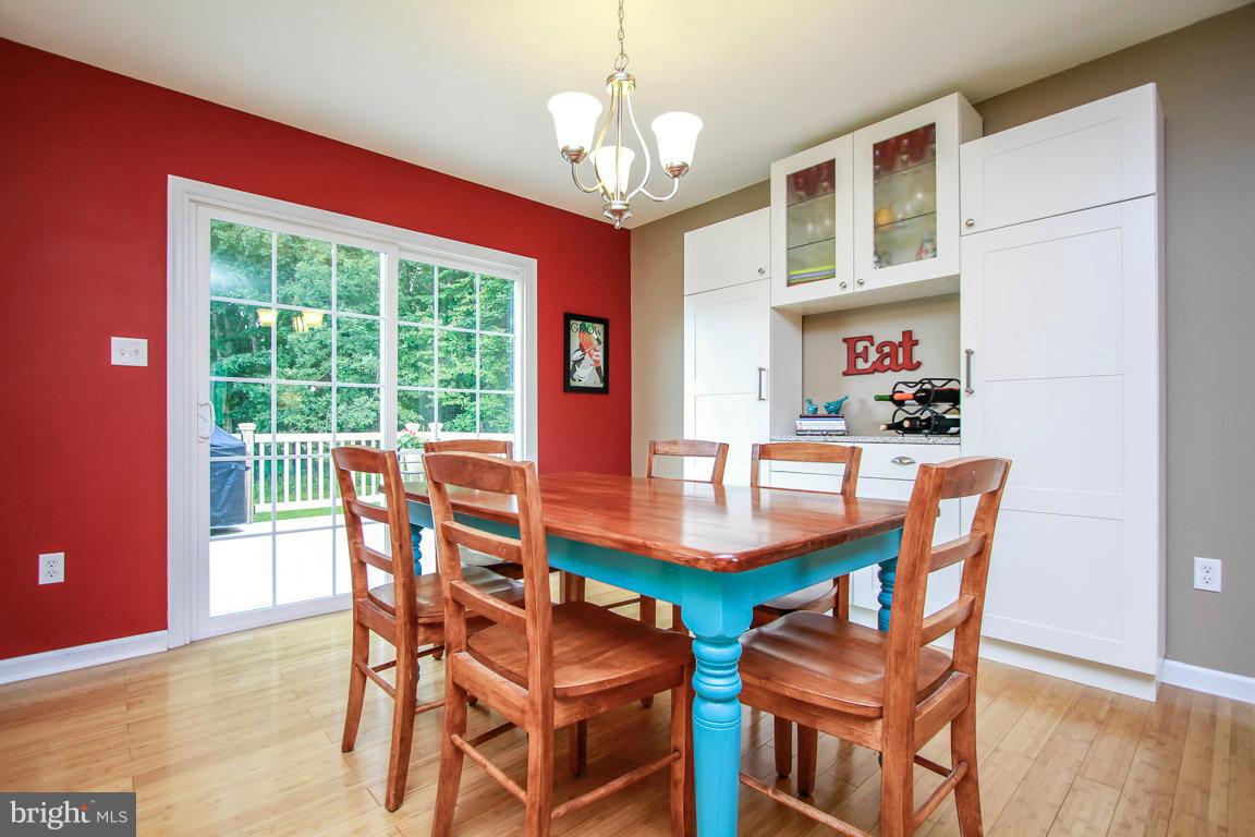 3237 Lineboro Road Manchester, MD 21102 - Photo 10 of 26 a dining room with furniture a chandelier and wooden floor