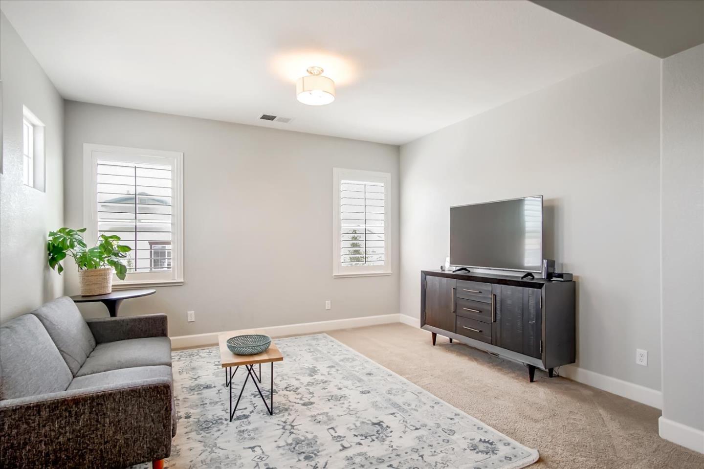 1130 Ruby Way Gilroy, CA 95020 - Photo 13 of 36 a living room with furniture and a flat screen tv