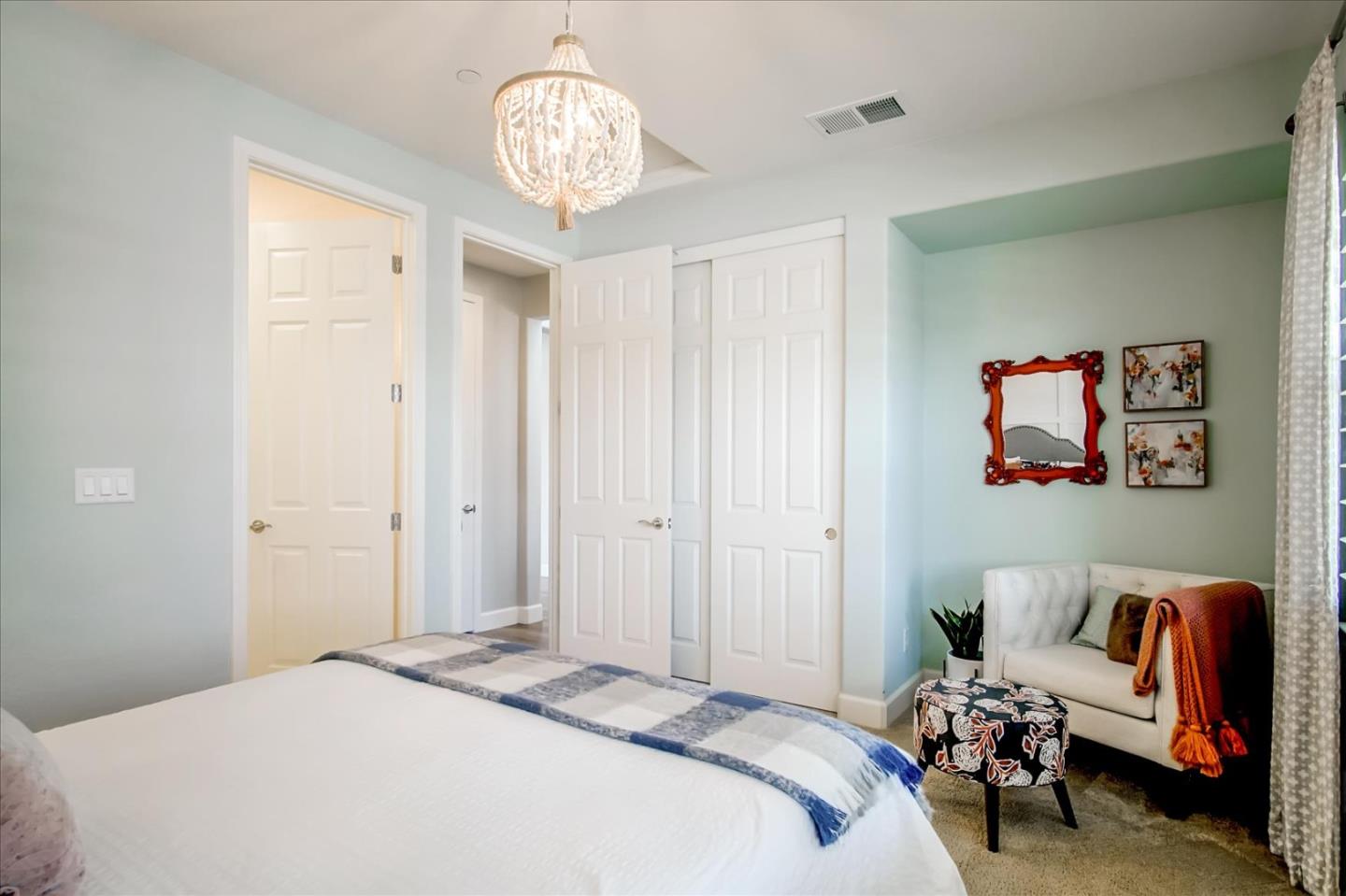 1130 Ruby Way Gilroy, CA 95020 - Photo 17 of 36 a bedroom with a bed and a chandelier