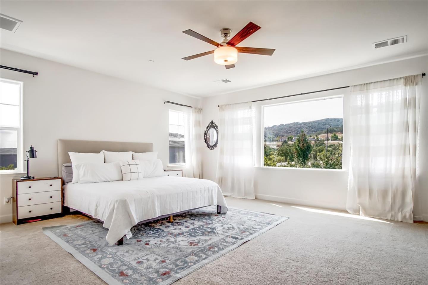 1130 Ruby Way Gilroy, CA 95020 - Photo 18 of 36 a bedroom with a large bed and a large window