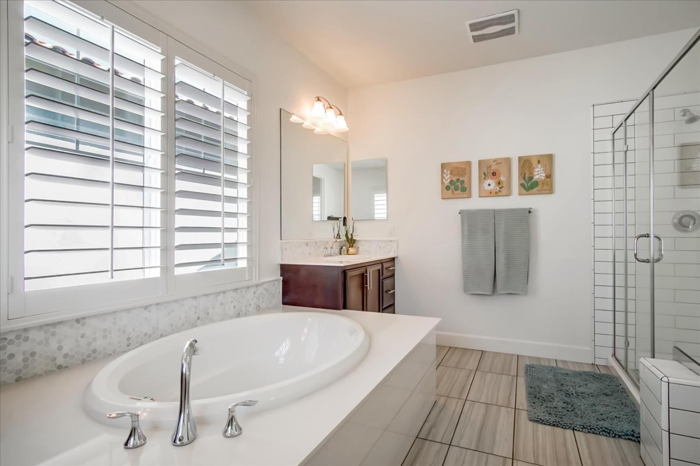 1130 Ruby Way Gilroy, CA 95020 - Photo 22 of 36 a bathroom with a tub a sink and a window