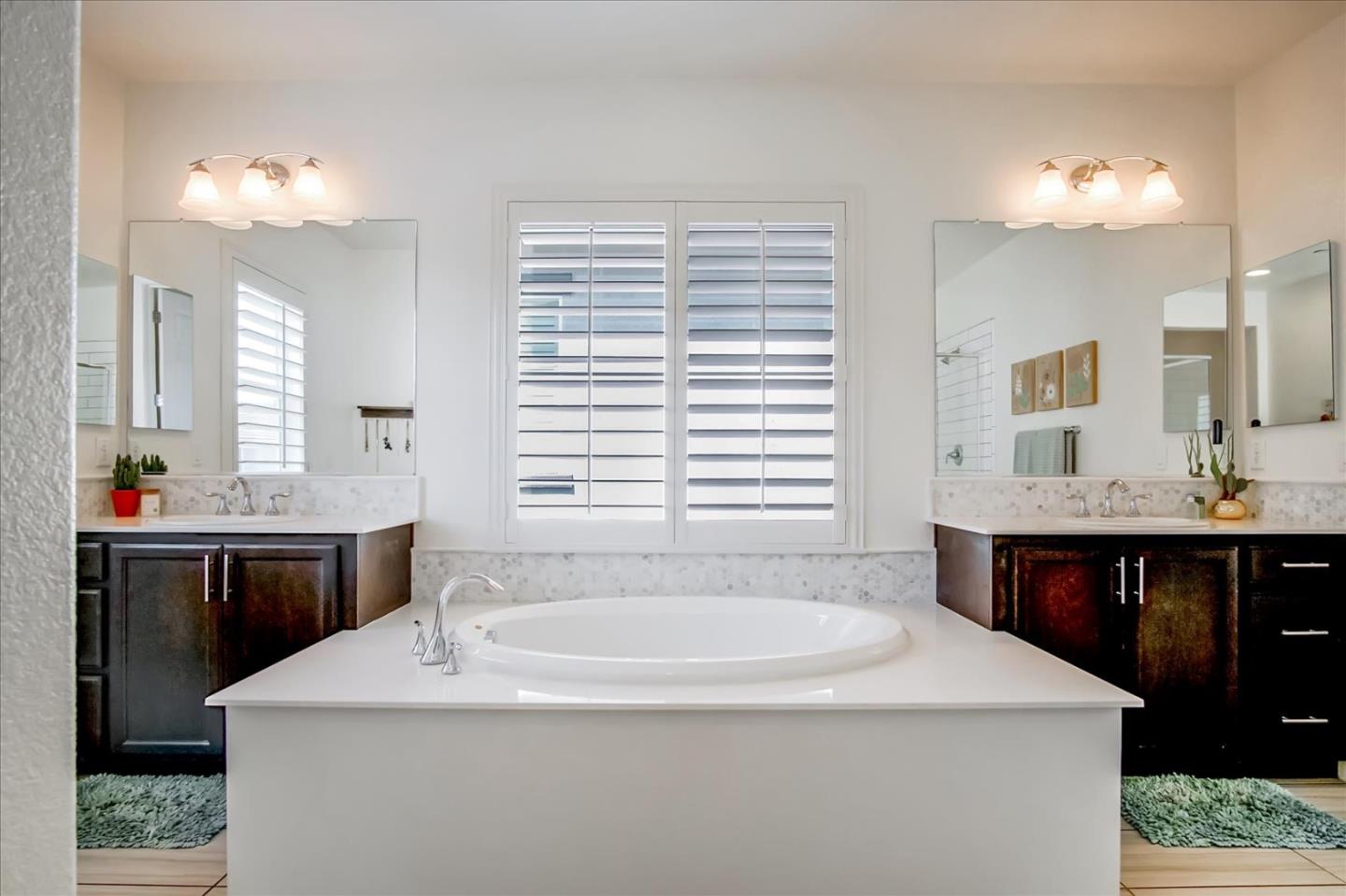 1130 Ruby Way Gilroy, CA 95020 - Photo 23 of 36 a bathroom with a sink and a mirror