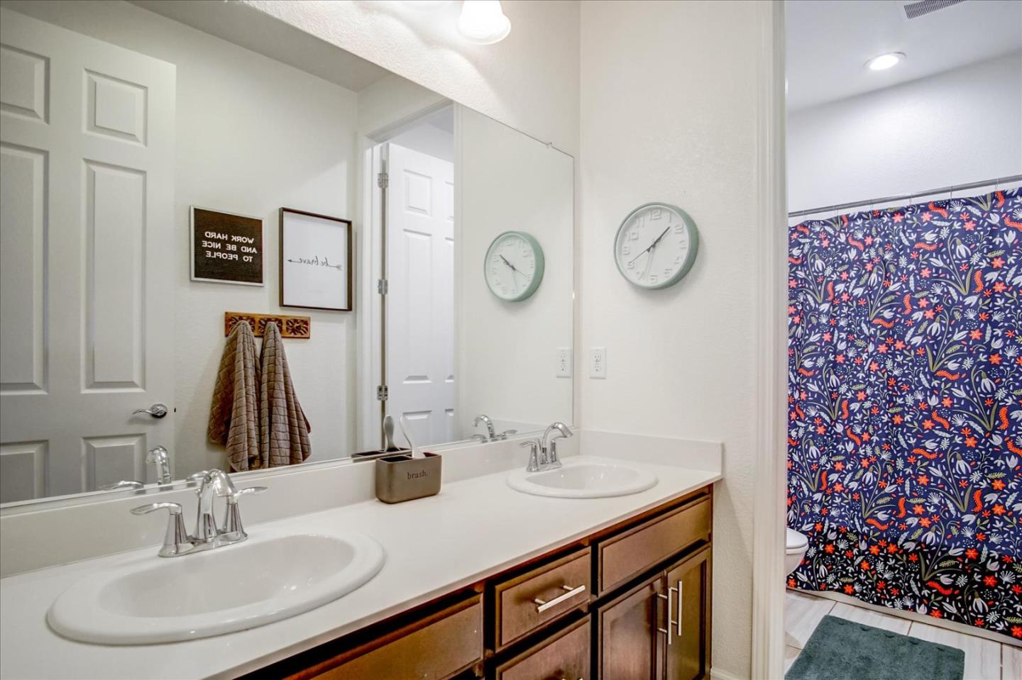 1130 Ruby Way Gilroy, CA 95020 - Photo 25 of 36 a bathroom with a double vanity sink and a mirror