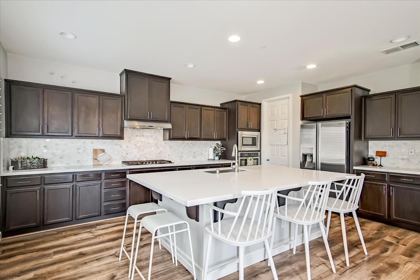 1130 Ruby Way Gilroy, CA 95020 - Photo 6 of 36 a kitchen with stainless steel appliances kitchen island granite countertop a sink and cabinets
