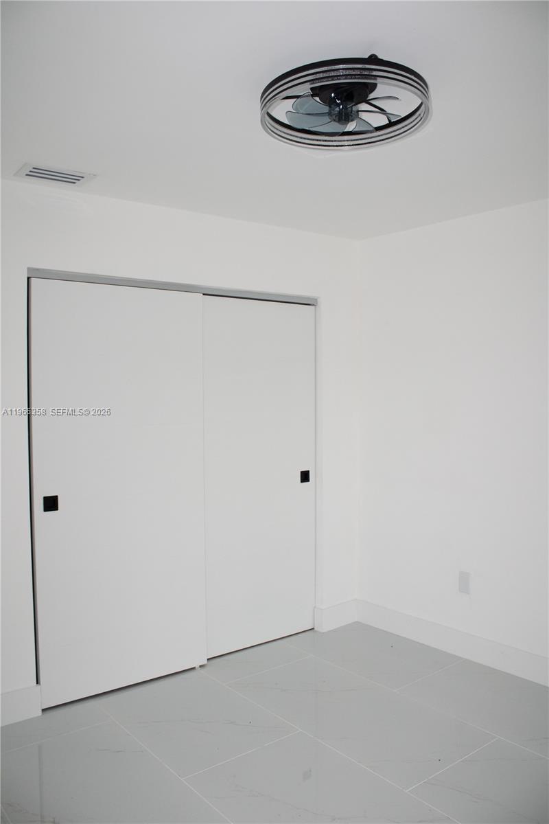 10433 Southwest 118th Court Miami, FL 33186 - Photo 15 of 32 a view of a room with a fan and a fan