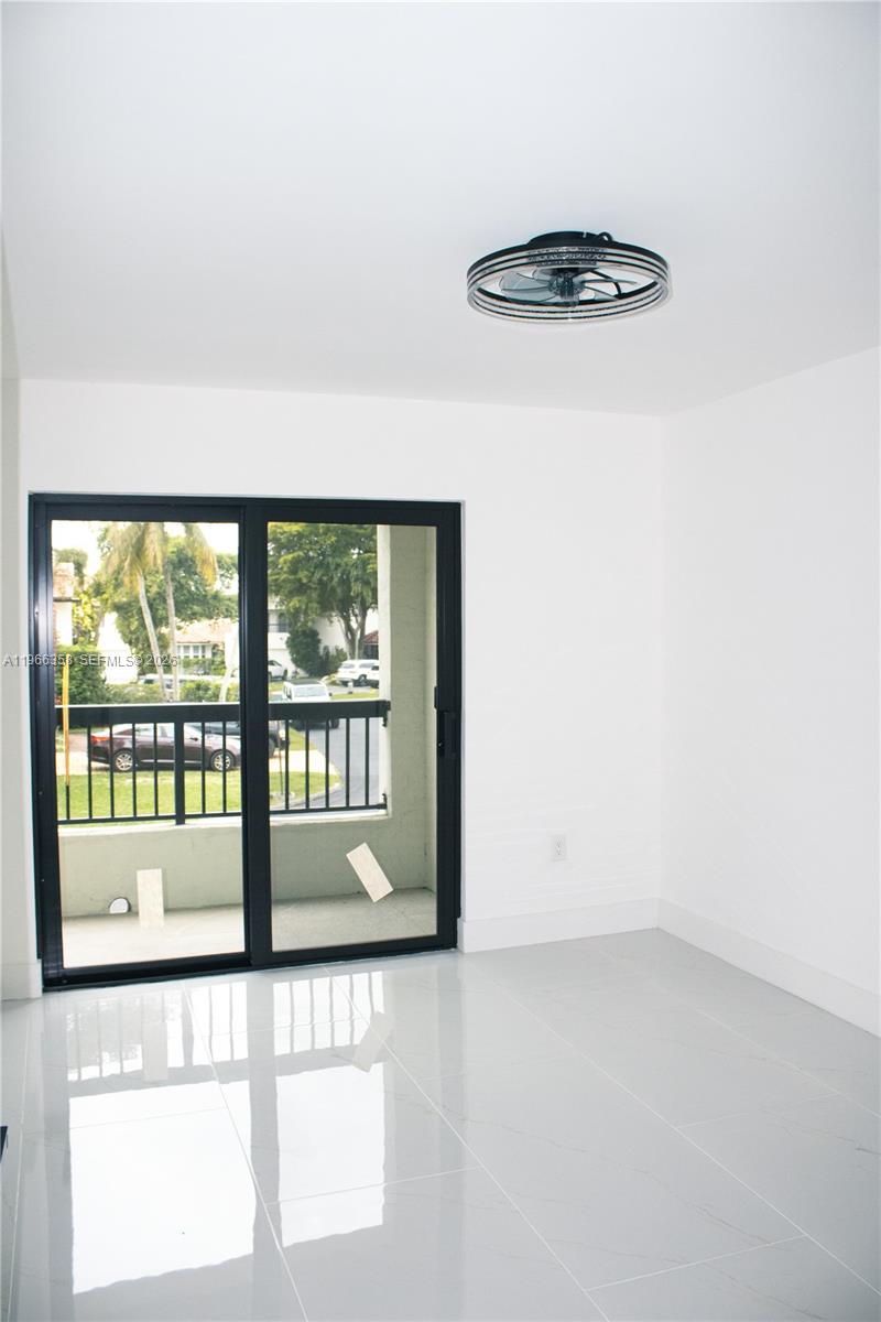 10433 Southwest 118th Court Miami, FL 33186 - Photo 18 of 32 a view of an empty room with a window