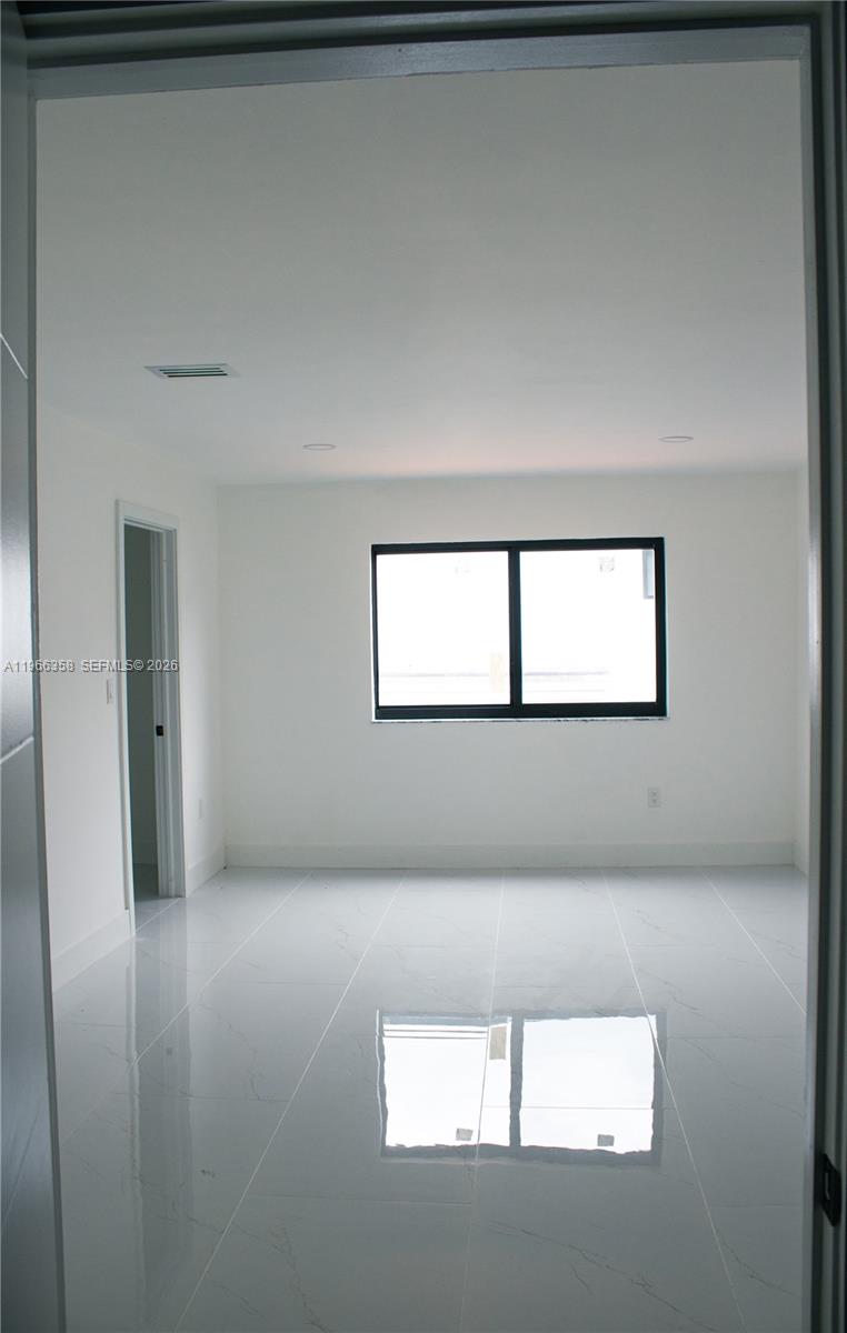 10433 Southwest 118th Court Miami, FL 33186 - Photo 19 of 32 a view of an empty room and window