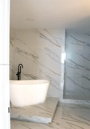 a bathroom with a granite countertop sink and mirror