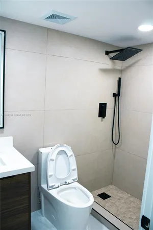 a bathroom with a toilet and a shower