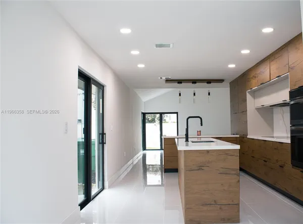 a bathroom with a sink a mirror and a bathtub