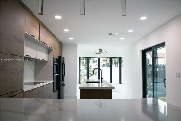 a view of staircase with lots of frames on wall and wooden floor