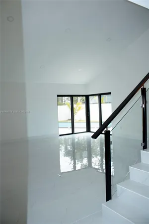 a view of staircase with white walls and a window