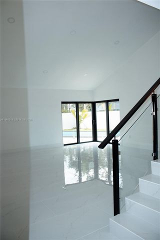 a view of staircase with white walls and a window