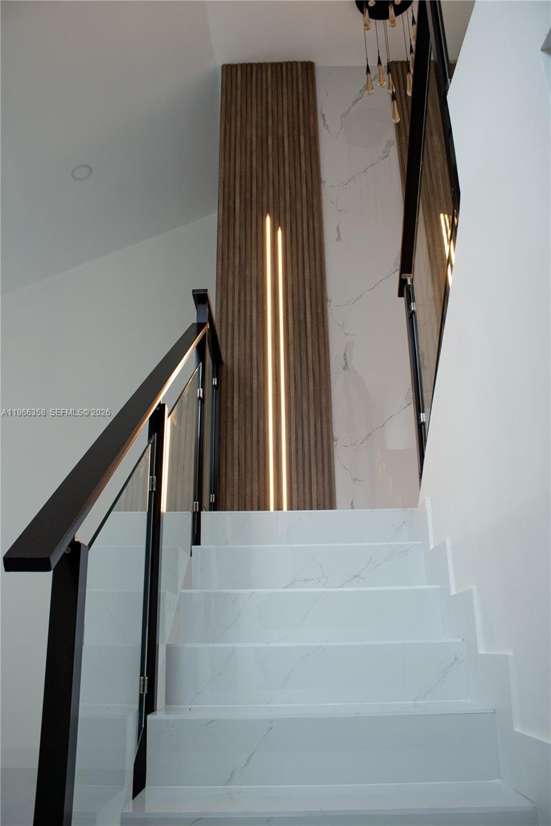 10433 Southwest 118th Court Miami, FL 33186 - Photo 10 of 32 a view of staircase with white walls and a window