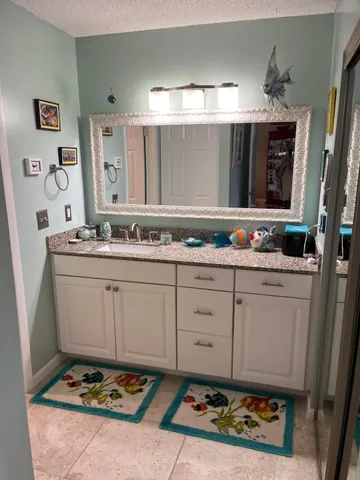 a bathroom with a sink a vanity and mirror