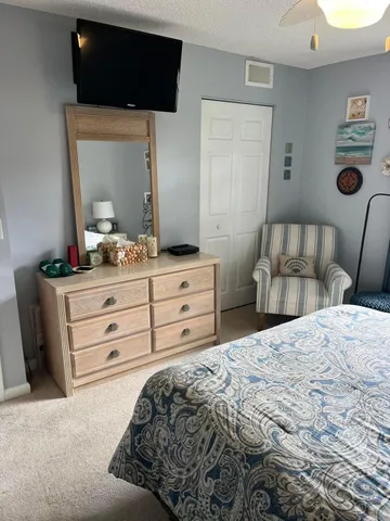 a bedroom with a bed and a mirror