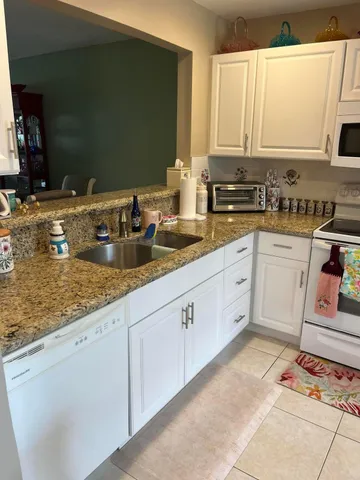 a kitchen with sink cabinets and window