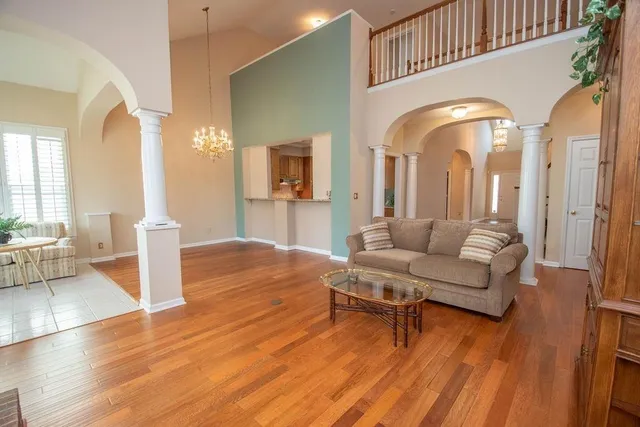 a living room with fireplace furniture and a wooden floor
