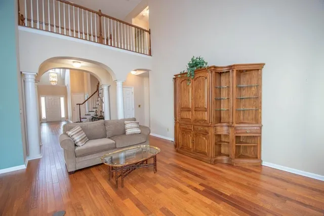 a living room with furniture and wooden floor