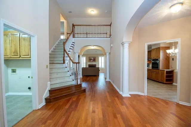 a view of a hallway view with wooden floor and staircase