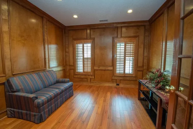a living room with furniture and wooden floor