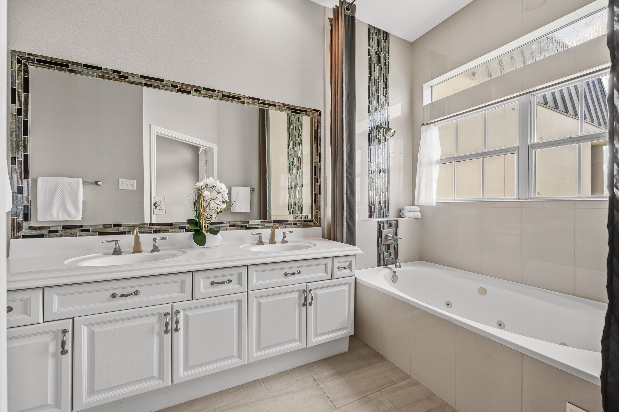 2918 Ranch Road 620 North, Unit S242 Austin, TX 78734 - Photo 26 of 35 Dual vanity sinks and a deep soaking tub complete this well-appointed primary bathroom.