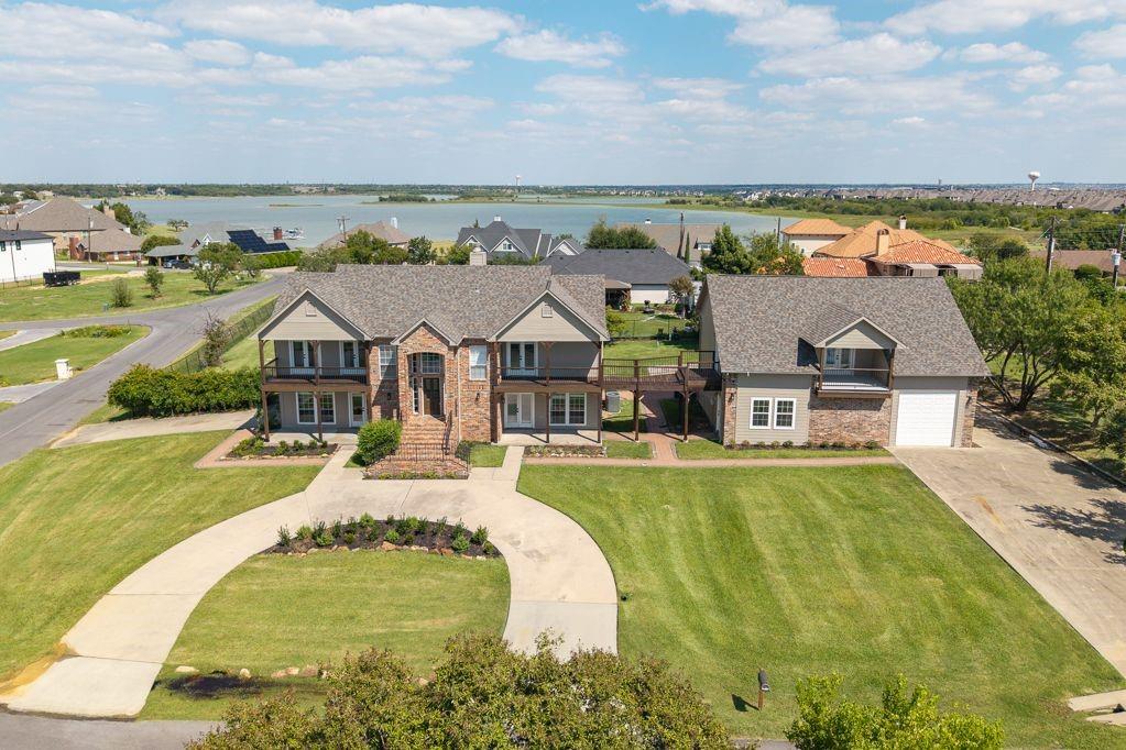 an aerial view of a house with a big yard and large trees